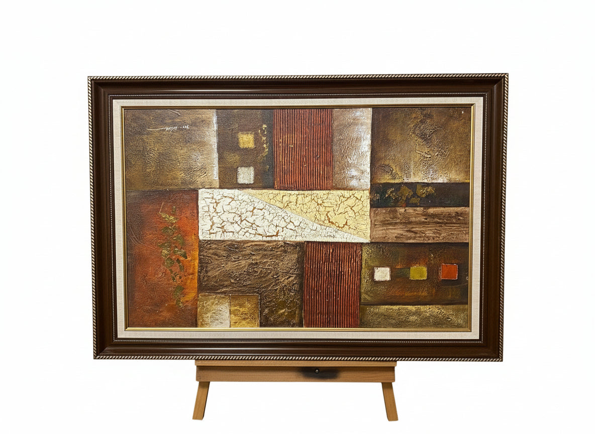 Abstract art piece with textured squares in a wooden frame on a gray background